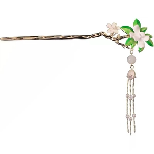 Pic à cheveux vintage doré avec fleur de gardénia blanche et long gland sur fond blanc