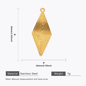 Detail of golden rhombus stainless steel pendant with textured concentric ripples