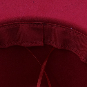 Detailed close-up of the red wool fedora interior sweatband and precision stitching