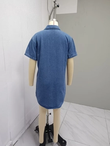 Detail view of the back of a blue short-sleeve denim shirt dress with a long relaxed fit