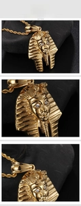 Vue détaillée du pendentif Pharaon égyptien doré avec yeux incrustés sur chaîne torsadée