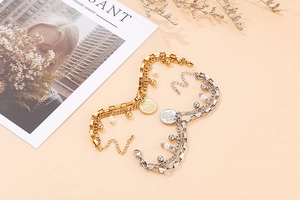 Close-up of double-layered titanium steel bracelets with coin pendants and pearls