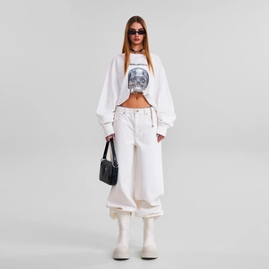 White skull print long sleeve cotton T-shirt with matching wide leg trousers and boots