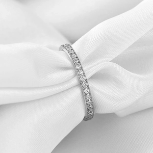 Close-up of 2mm silver stainless steel eternity ring with cubic zirconia on white silk