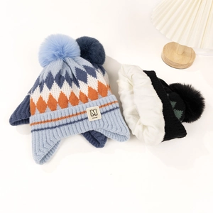 Detail of warm winter knit hat with white fleece lining and ear protection design