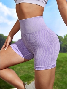 Detail of high-waist purple zebra print yoga shorts with seamless compression fabric