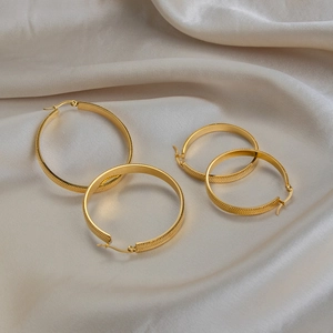 Retro 18K gold plated stainless steel snake chain hoop earrings on silk background