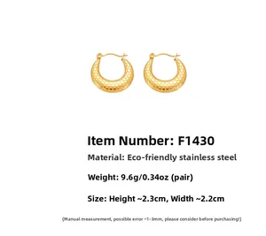 Detail view of gold stainless steel C-shaped earrings with a fish scale texture pattern