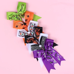 Detail of Halloween hair bows with festive patterns like pumpkins and spider webs