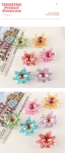 Macro shot of colorful iridescent flower hair claw clip with pearl center detail