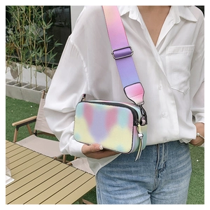 Detail of colorful gradient camera bag with wide strap and double silver zippers