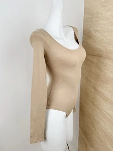 Detail view of khaki ribbed cotton bodysuit featuring a U-neck and form-fitting sleeve