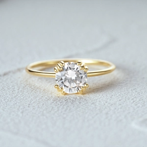 Detail of a gold plated silver ring with a sparkling round brilliant cut center diamond