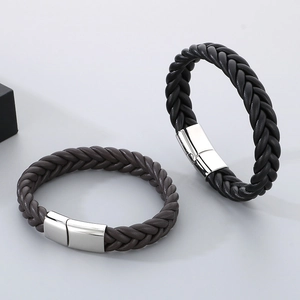 Close-up of woven leather bracelets in black and dark brown with magnetic metal clasps