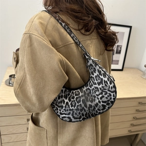 Retro leopard print crescent shoulder bag shown on model with vintage brown jacket
