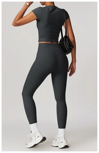 Detail view of high waisted dark grey yoga leggings with a V-shaped back seam design