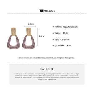 Detailed view of geometric drop earrings with dimensions 4.6x2.6cm and rhinestone inlay