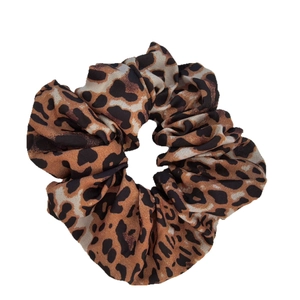 Classic leopard print elastic hair scrunchie with soft satin texture on white background