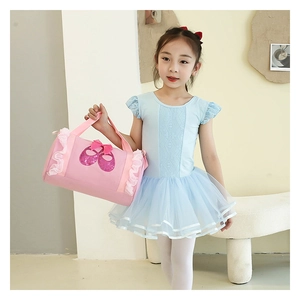 Close-up of light blue ballet tutu dress with lace details and pink sequin dance bag