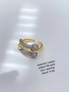Detail of 18K gold plated two-tone adjustable ring with micro-pave cubic zirconia