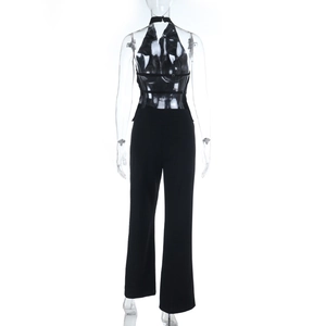 Detail view of the back of a black halter jumpsuit with criss-cross straps