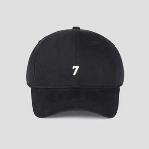 Detailed close-up of a black cotton baseball cap with white number 7 embroidery on front