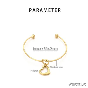 Detailed view of 18K gold plated stainless steel knot bangle with heart pendant and dimensions