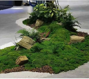 Detailed view of artificial moss mossy lawn with landscape stones and wood bark mulch