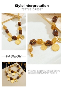 Detail view of amber resin beaded necklace and bracelet with embossed gold coin pendants