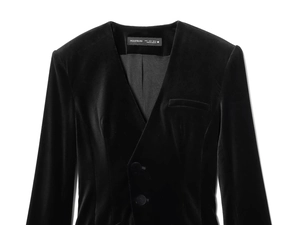 Detailed view of the V-neck velvet romper featuring button closure and a front welt pocket