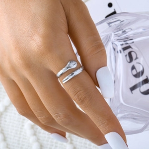 Detail shot of silver adjustable snake ring featuring a textured hammered metal finish