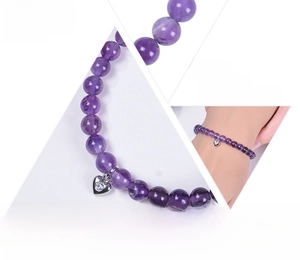 Detailed view of 6mm amethyst bead bracelet with silver heart pendant and diamond accents