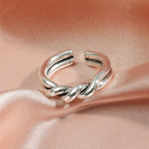 Detailed view of the twisted rope design on an adjustable silver braided metal ring