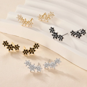Macro view of four pairs of S925 silver flower stud earrings with zircon inlays