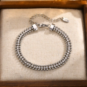 Detailed macro view of triple-layered 18K gold chain bracelet with sparkling zircon stones