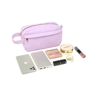 Purple corduroy cosmetic bag with top handle showing high capacity for makeup storage