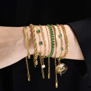 Gold stainless steel bracelet set for women featuring green zircon and snake chain detail
