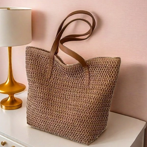 Large straw tote bag with brown leather handles for summer beach commute travel