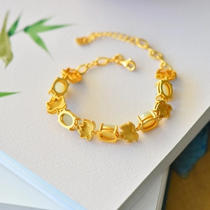 Detail of matte gold lotus bracelet with white jade inlay and adjustable lobster clasp
