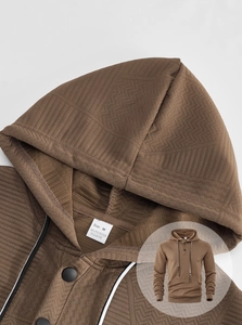 Close-up of brown waffle texture and fabric tag on casual long sleeve hoodie