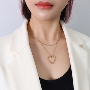 Close-up of double-layer 18k gold plated choker with heart pendant on a model