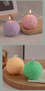 Close-up of pastel flower-shaped scented candles with detailed rose carving textures