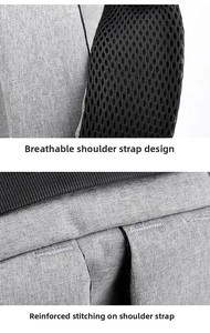 Detail of breathable mesh shoulder straps and reinforced stitching on gray business backpack