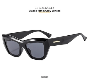 Detailed side view of black cat-eye sunglasses with gold metal temple accents