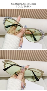 Close-up of cat-eye sunglasses with gold metal frame, green lenses and rhinestone detailing