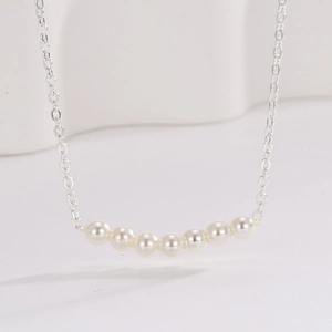 Minimalist S925 sterling silver necklace with seven lustrous white pearls in a horizontal row
