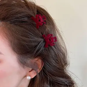 Detail view of red velvet bow hair clips with traditional Xi character for weddings