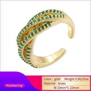 Luxurious crisscross brass ring with green cubic zirconia and gold plating finish