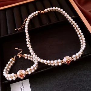 Vintage gold-plated pearl jewelry set with double-row necklace and matching bracelet