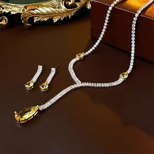 Luxury yellow teardrop zircon necklace and earring set on premium leather display